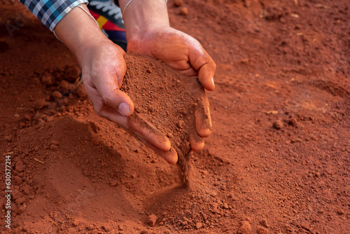 Hands cradling the soil evoke a sense of care and responsibility, representing the essential role play in cultivating and sustaining the environment.