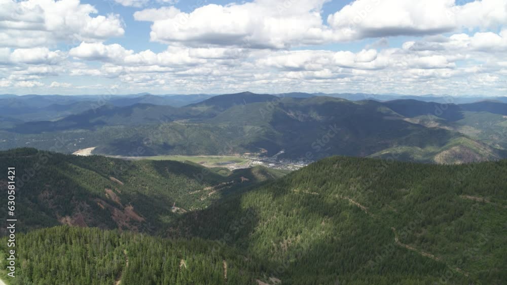 High wide aerial above Kellogg Idaho in summer from forest mountain peaks High wide aerial above Kellogg Idaho in summer from forest mountain peaks