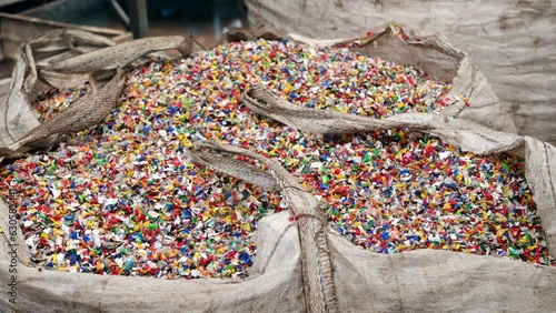 Sack of sorted multicoloured plastic garbage at waste recycling factory photo