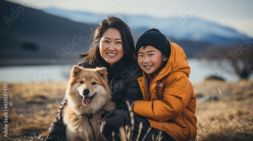 woman and son travelling with Siberian Husky dog. beautiful smile. mountain and lake view background in the daylight morning. © banthita166
