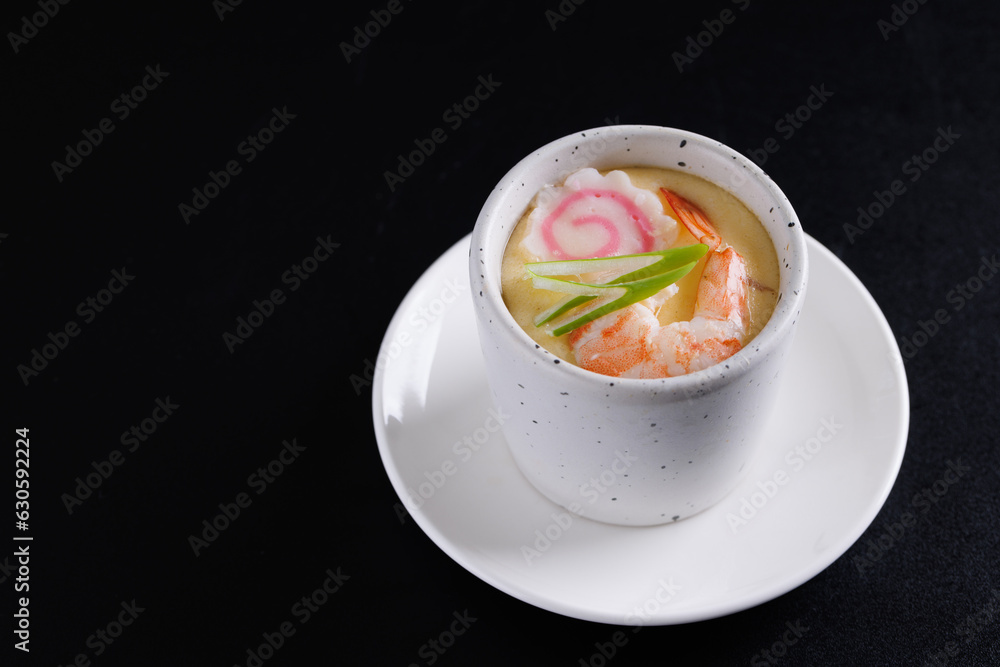 Japanese Traditional food Eggs Custard Chawanmushi isolated in black background Japanese Traditional food Eggs Custard Chawanmushi isolated in black background