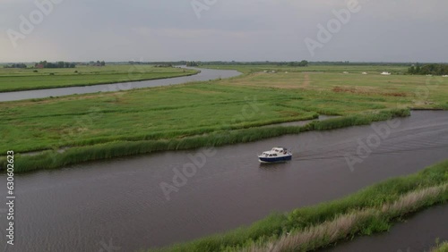 Motorboat cruising on canals of alde feanen national park Friesland, aerial photo