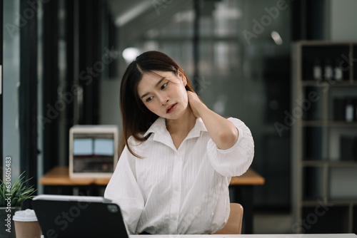 Women sitting at home office workplace gesture neck pain office syndrome concept.