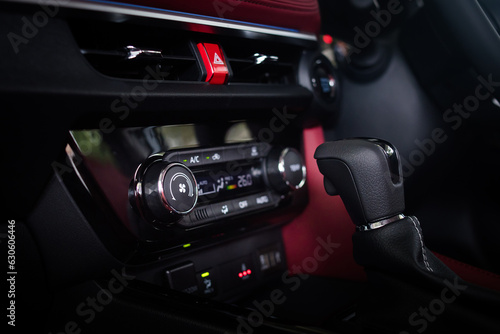 Close up auto air conditioning adjustment button. Car air conditioning control unit with temperature status display. 