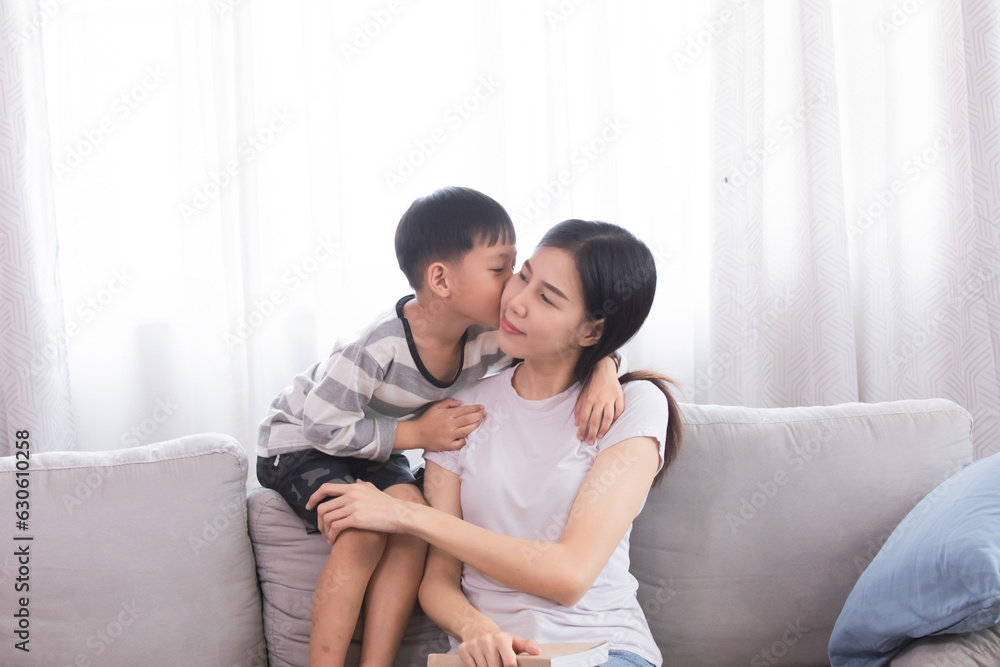 Asian funny son teasing mom and kissing her cheek, Adorable little boy gives love to single mother on mother's day with tenderness. Overjoy bonding cheerful kid embrace relationship. Asian funny son teasing mom and kissing her cheek, Adorable little boy gives love to single mother on mother's day with tenderness. Overjoy bonding cheerful kid embrace relationship.