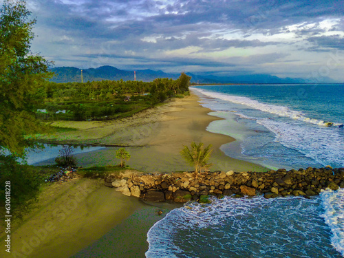 the beautiful Bali Beach in Blangpidie, South West Aceh, Indonesia with blue ocean against the blue sky shot with aerial drone. photo
