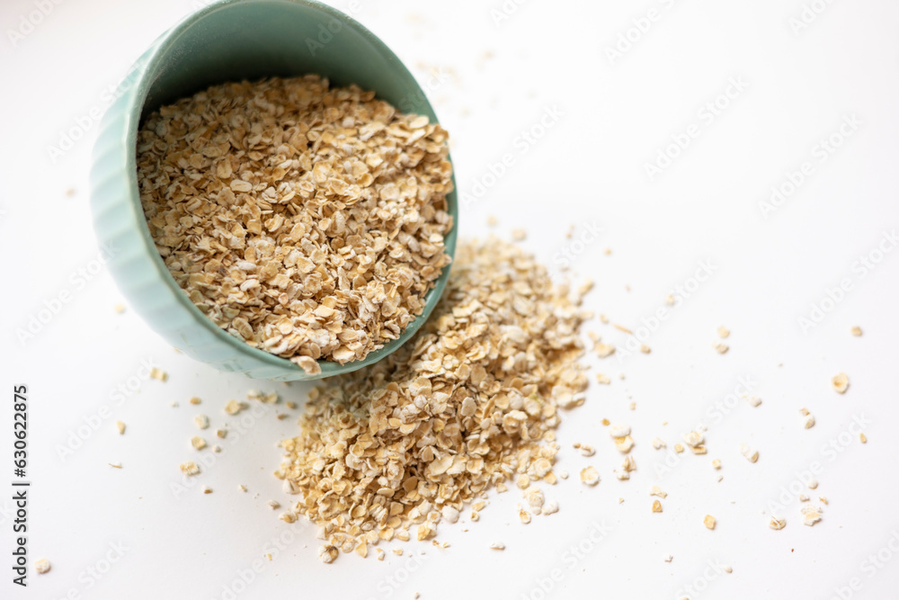 oats in a small blue bowl isolate on white background oats in a small blue bowl isolate on white background