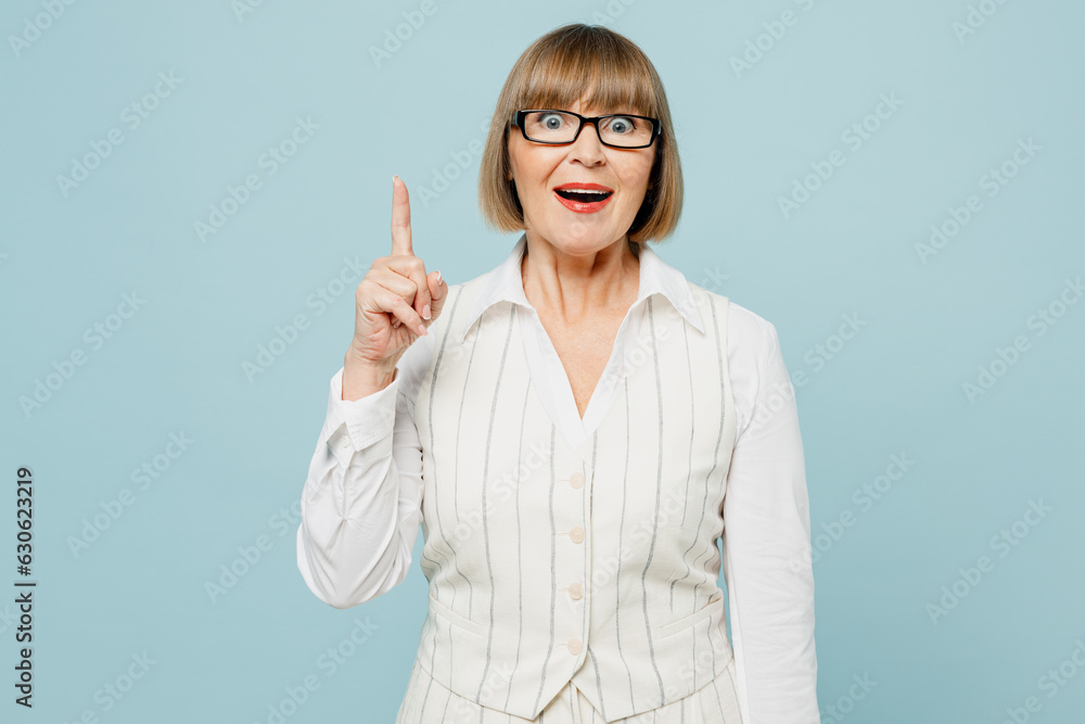 Blonde employee business woman 50s wear white classic suit glasses formal clothes holding index finger up with great new idea isolated on plain pastel light blue background Achievement career concept Blonde employee business woman 50s wear white classic suit glasses formal clothes holding index finger up with great new idea isolated on plain pastel light blue background Achievement career concept