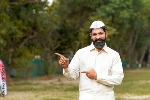 Indian or marathi man in traditional wear and giving expression at park. photo