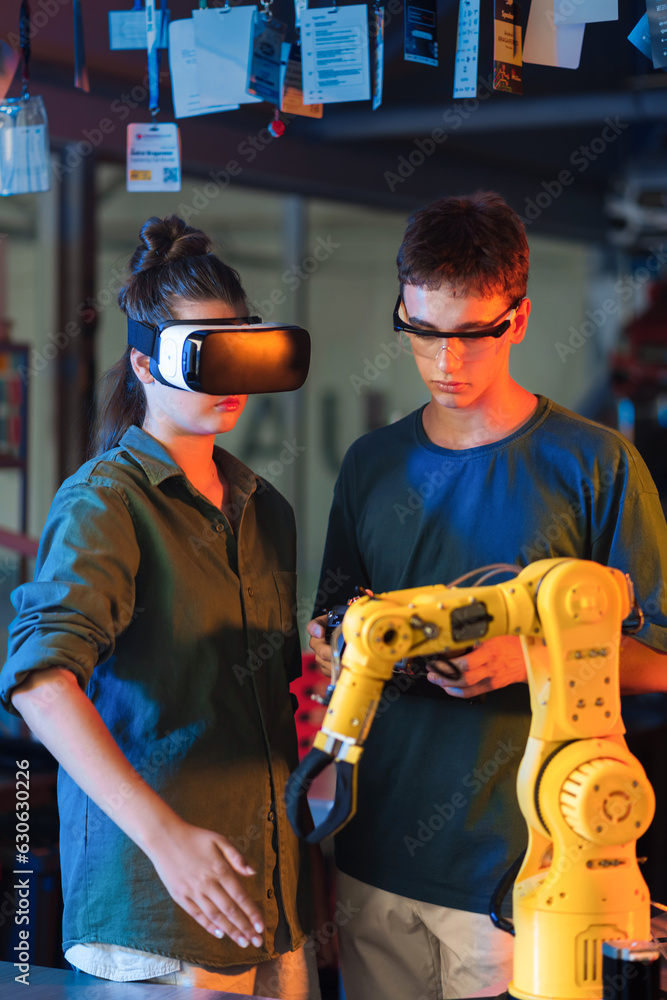 Teens remotely controlling robots in a laboratory