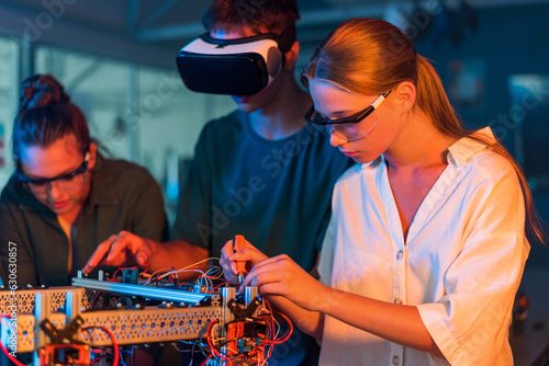 Teens doing experiments in robotics in a laboratory