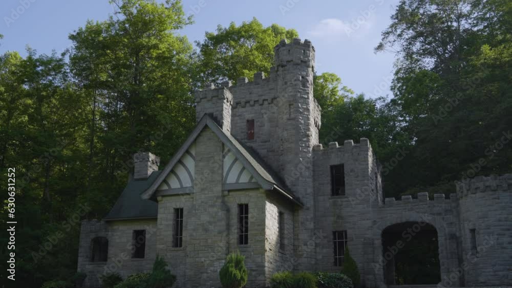 stately stone castle against a wooded backdrop with blue skies stately stone castle against a wooded backdrop with blue skies