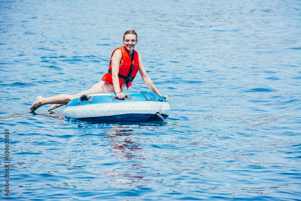 Woman enjoying the sea on an inflatable donut Woman enjoying the sea on an inflatable donut