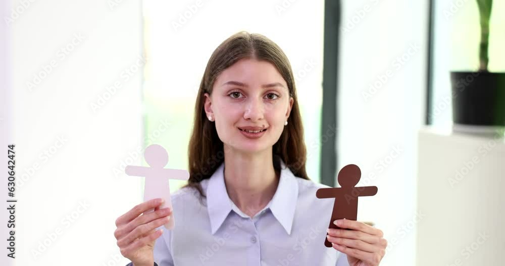 Symbol of man and family interracial marriages and relationships woman holding paper cut figurines. Happy interracial family Symbol of man and family interracial marriages and relationships woman holding paper cut figurines. Happy interracial family