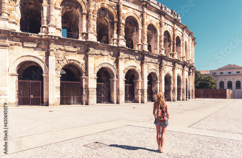 Woman tourist enjoying ancient Roman amphitheatre in Nimes, Gard in France