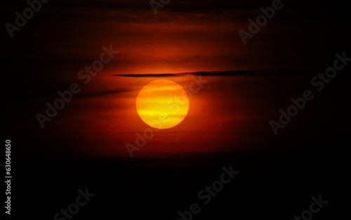 Close up view of sun rising up in the morning through the clouds. Sunspots on the sun  sunrise concept photo.