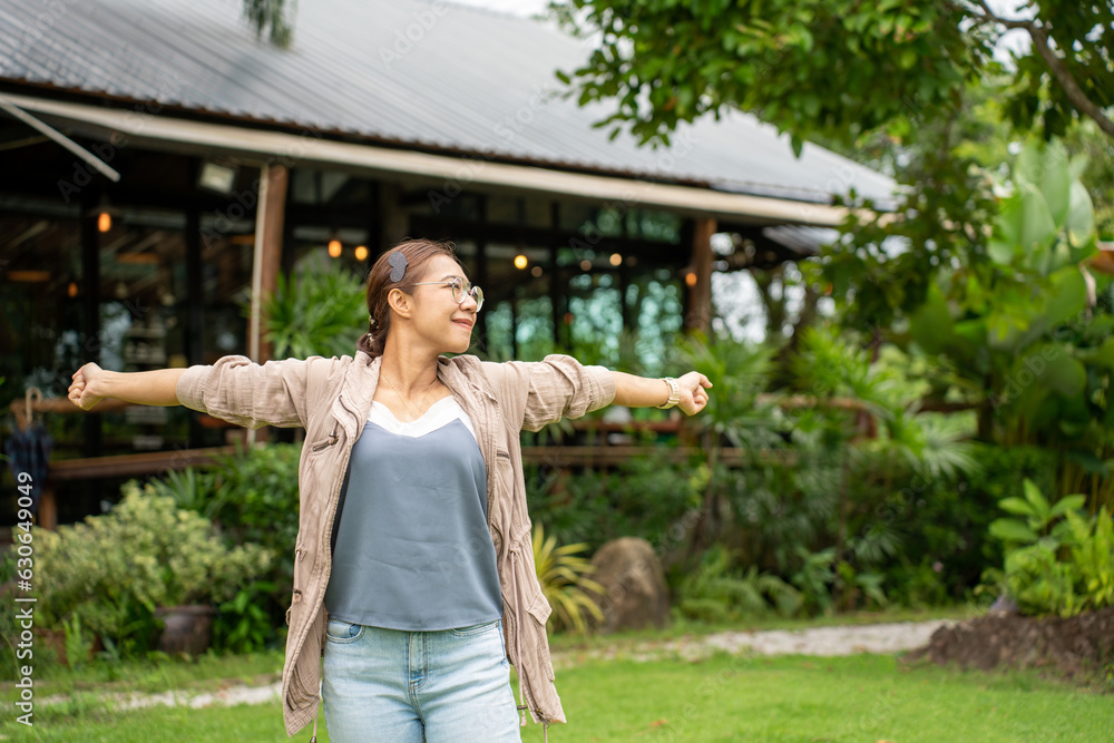 Fototapeta premium beautiful Refreshed woman in the Graden. Happy woman at Coffee Shop Garden.