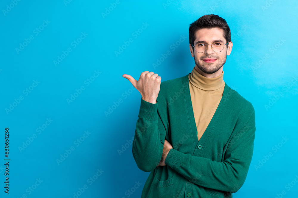 Portrait of confident corporate representative man indicate thumb finger empty space novelty isolated on blue color background Portrait of confident corporate representative man indicate thumb finger empty space novelty isolated on blue color background