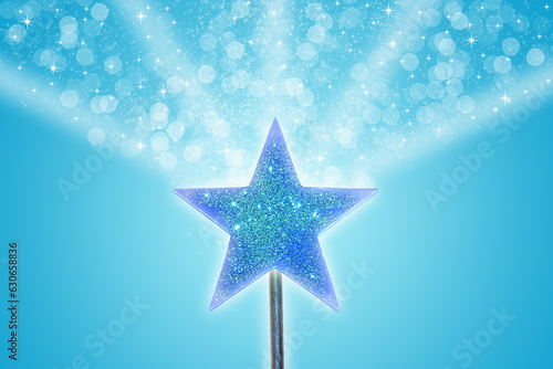 A vibrant blue magic wand emitting glowing magic particles into a blue background. 
