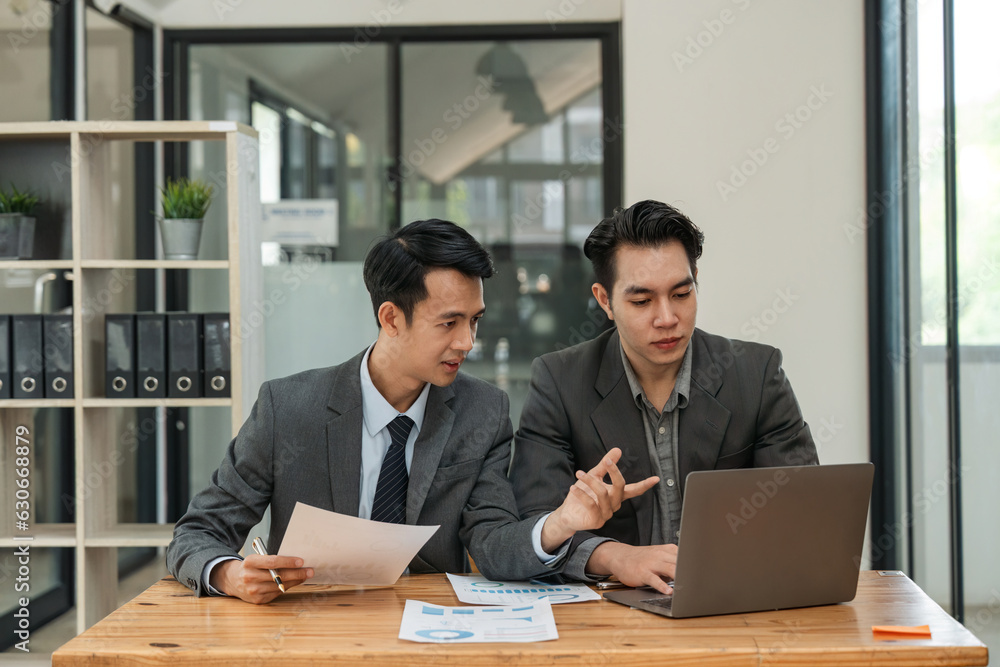 Asian business adviser meeting to analyze and discuss the situation on the financial report in the meeting room. Investment Consultant, Financial Consultant, Financial advisor and accounting concept Asian business adviser meeting to analyze and discuss the situation on the financial report in the meeting room. Investment Consultant, Financial Consultant, Financial advisor and accounting concept