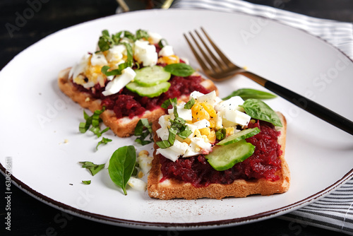 Healthy toast with pate beetroot, boiled eggs, basil and cucumbers. Delicious breakfast or snack.