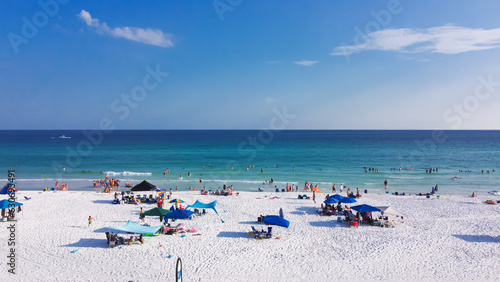 Colorful beach umbrella and people swimming, laid-back relaxing on sugar-white sand beaches, crystal clear clean gorgeous shade of blue turquoise water Destin, South Walton, Florida, USA © trongnguyen