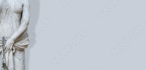 Banner with old statue of sensual bathing Renaissance Era woman at solid grey background with copy space and shadow. Concept of woman beauty