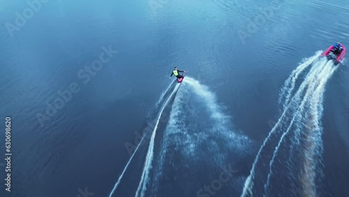 Kneeboarder cutting out behind speed boat High angle Aerial photo