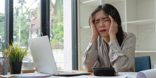 Obraz na plátně Asian business woman got stressed at work during in the office room, stressed fa
