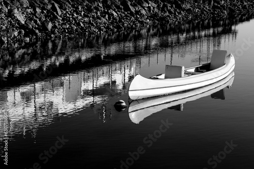 Canoe anchored on calm water in Tavira
