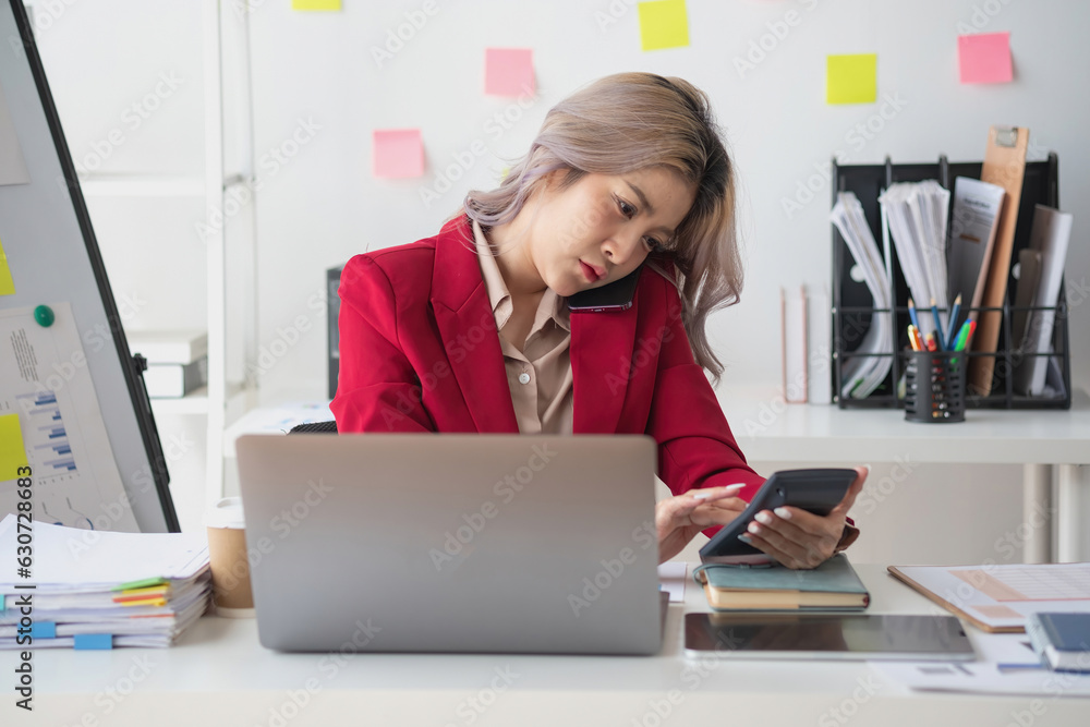 Busy businesswoman at work and talking on the phone looking at laptop screen Frustrated young woman arguing with customer holding a smartphone and being stressed solve business problems. Busy businesswoman at work and talking on the phone looking at laptop screen Frustrated young woman arguing with customer holding a smartphone and being stressed solve business problems.