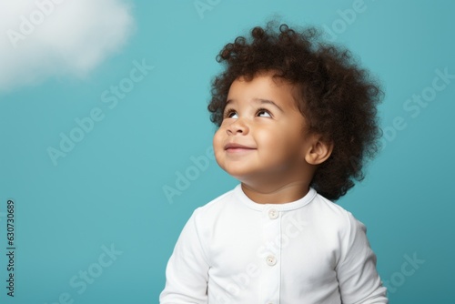 Child model in the studio on a colored background. Portrait with selective focus and copy space
