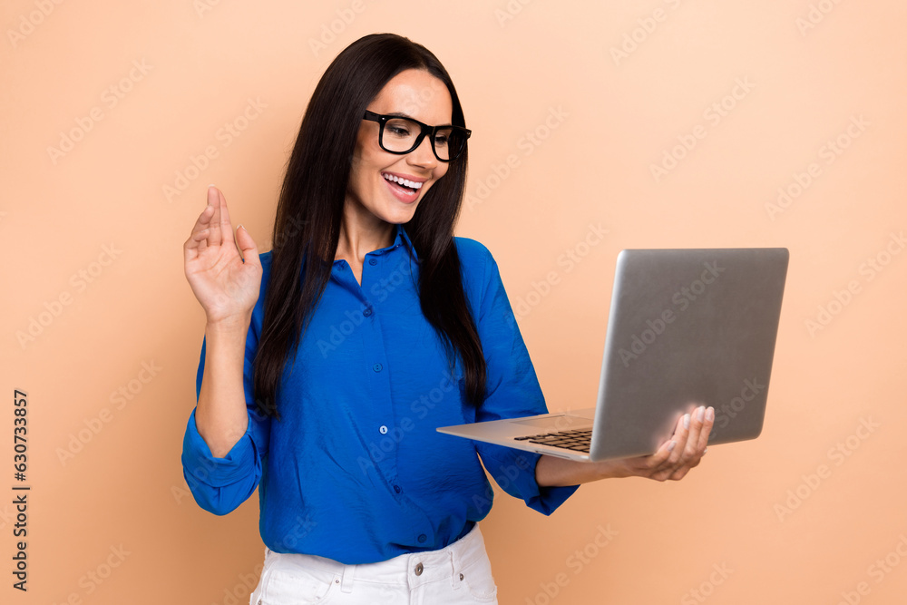 Photo of cheerful pretty lady arm palm waving hi communicate video call netbook isolated on beige color background Photo of cheerful pretty lady arm palm waving hi communicate video call netbook isolated on beige color background