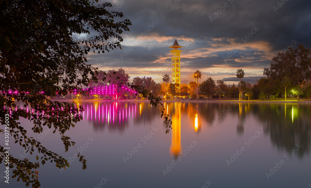 View of The Yuregir Clock Tower from Adana Central Park, in the Province of Adana. Seyhan River and Suspension Bridge