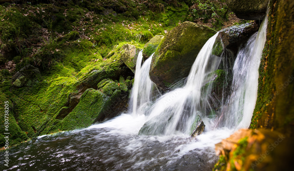 Obraz premium KRNAP (Krkonossky National Park), Czech Republic Krkonose mountains - waterfall scenic nature moss green background - white wild water falling from rocks making romantic veils.