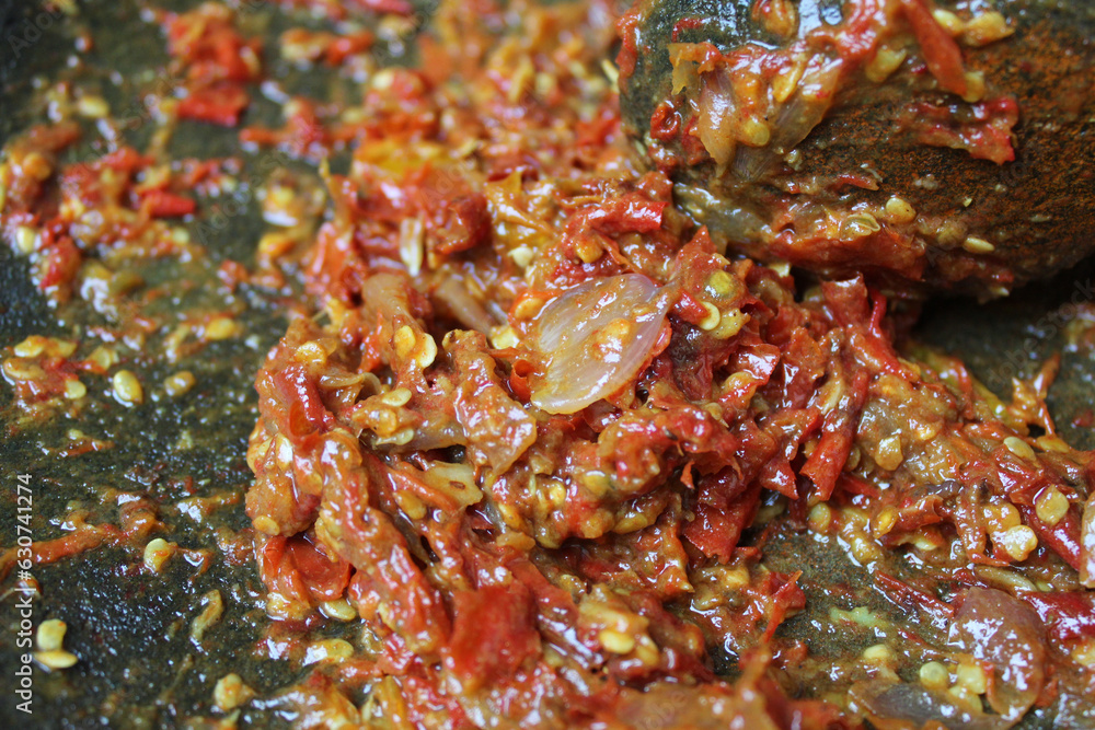 Sambal is an Indonesian chilli sauce or paste, made from red chili pepper and onion, mashed by stone mortar and pestle. Sambal is an Indonesian chilli sauce or paste, made from red chili pepper and onion, mashed by stone mortar and pestle.