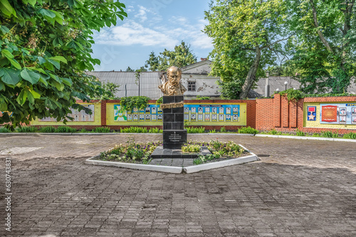Trostyanets, Sumy Oblast, Ukraine - June 18,2023: Bust of Taras Shevchenko against the background of tourist information boards on the city square in Trostianets. Monument to the famous Ukrainian poet