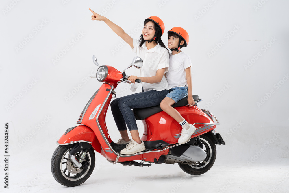 mother and son wearing helmets and riding motorbikes mother and son wearing helmets and riding motorbikes