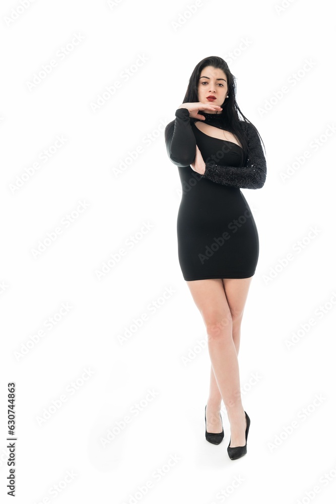 Young woman wearing black dress and standing on white background Young woman wearing black dress and standing on white background