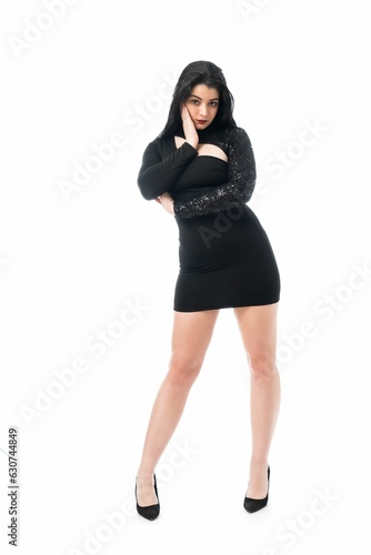 Young woman wearing black dress and standing on white background photo