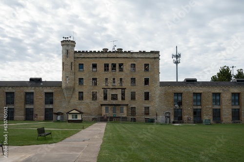 Facade of the historic Joliet Prison against a cloudy sky photo