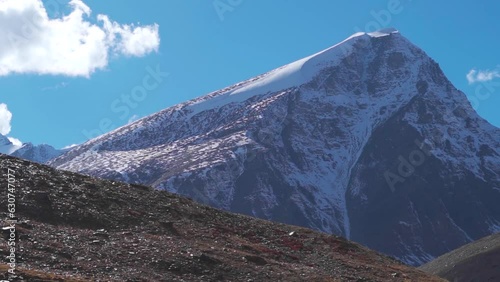 Snow covered Himalyan mountain peak at Shinkula Pass on the way to Zanskar in Himachal Pradesh, India. View of the snow covered mountain during the day in the Himachal. Natural winter background. photo