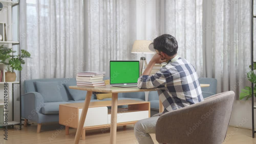 Bored Teenage Boy Learning Online From Laptop With Green Mock Up Screen At Home
Bored Teenage Boy Learning Online From Laptop With Green Mock Up Screen At Home