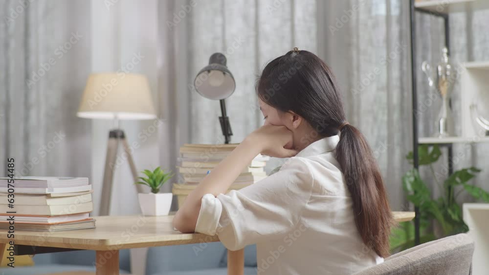Back View Of Bored Asian Teenager Studying At Home, Asia Teen Writing While Sitting On The Table
Back View Of Bored Asian Teenager Studying At Home, Asia Teen Writing While Sitting On The Table