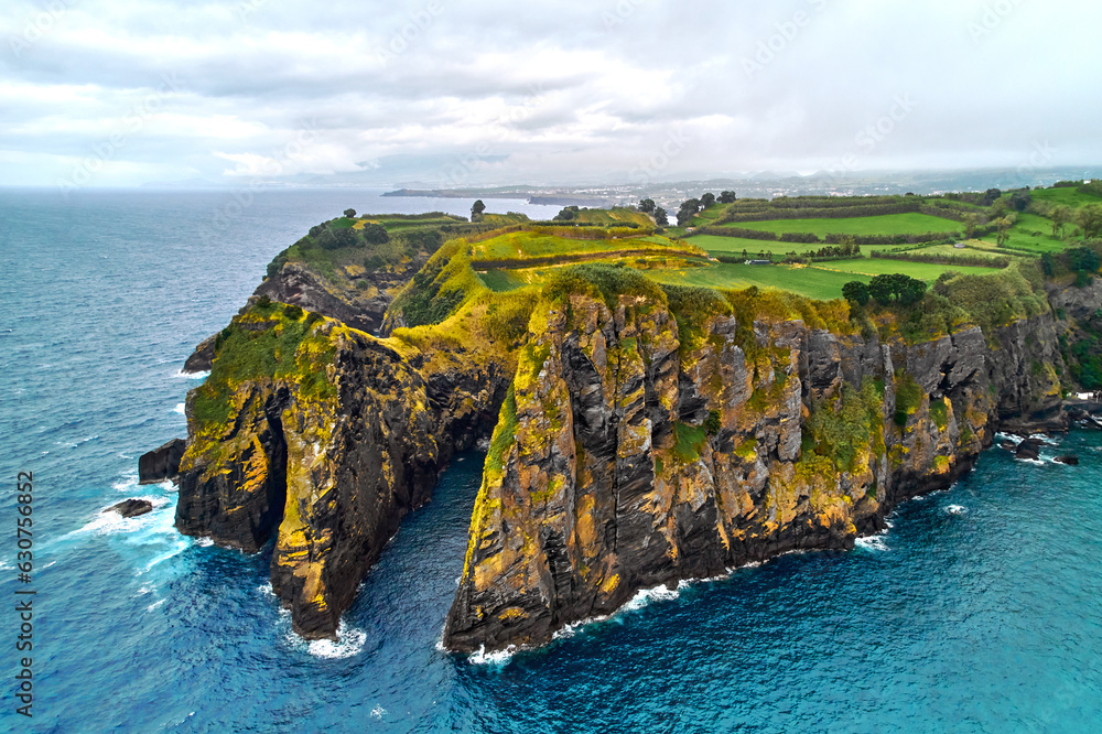 Naklejka premium Atlantic Ocean surf, rocky coastline and farmlands of Ponta Delgada