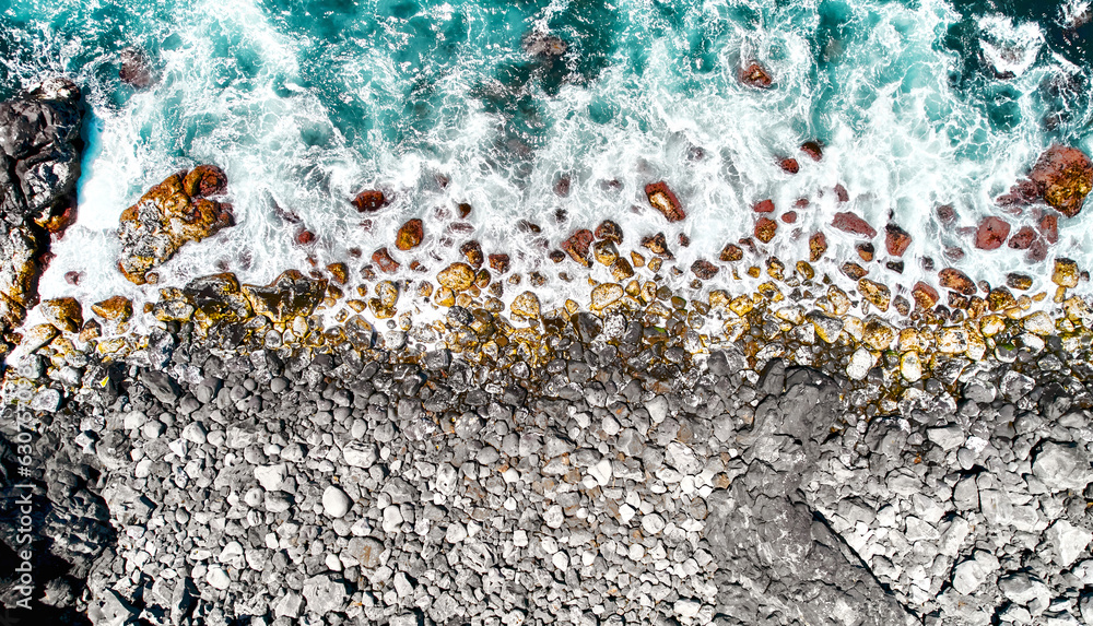 Obraz premium Aerial shot stony volcanic beach. Azores, Portugal