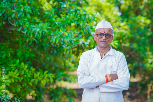 Indian farmer folding hand with farm field.