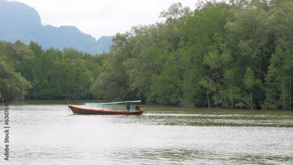a small boat with local people sailing in the river. a small boat with local people sailing in the river.