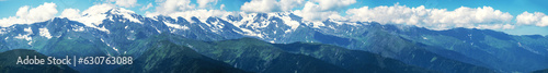 Mountain landscape panorama, horizontal banner image. Snow covered mountain rage in sunny summer day.