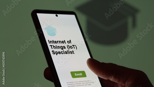 03th August 2023. A student holds a phone, enrolls in courses to study internet of things (iot) specialist program, learn new skill and pass certification. Text in English, English text. photo